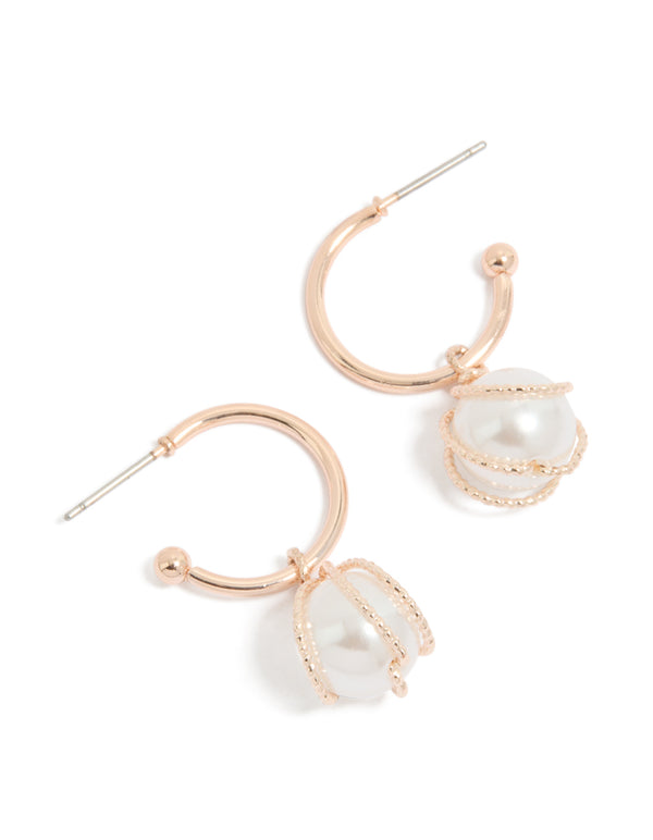 Showcasing rose gold pearl wire wrap hoop earrings front view