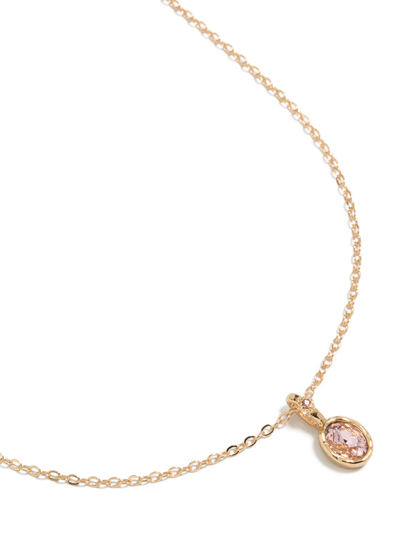 Beautifully crafted pink diamante round pendant charm necklace in gold featuring a delicate chain close up view