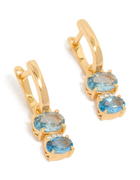 Showcasing gold plated light blue cubic zirconia circles huggie earrings with closure front view - link has visual effect only