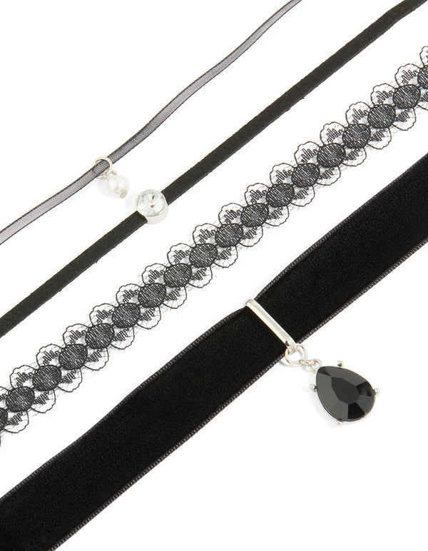 Showcasing a black lace and teardrop choker necklaces 4-pack with pearl accents in silver and clear close up view