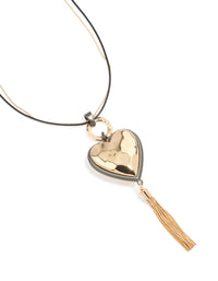 Showcasing a mixed metal chunky heart tassel cord layered necklace featuring charm details in silver and gold close up view - link has visual effect only