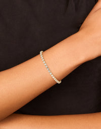 Showcasing a waterproof gold plated stainless steel cubic zirconia tennis toggle bracelet with sparkling stones, on wrist view - link has visual effect only