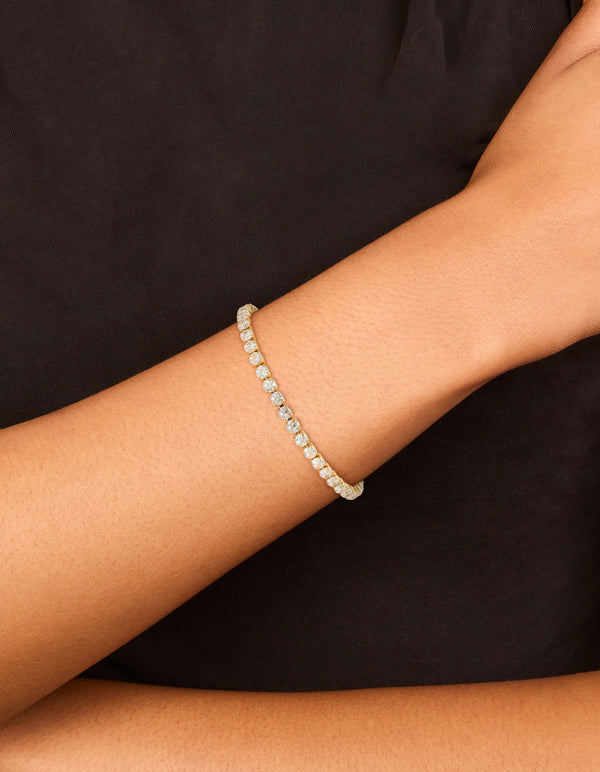 Showcasing a waterproof gold plated stainless steel cubic zirconia tennis toggle bracelet with sparkling stones, on wrist view