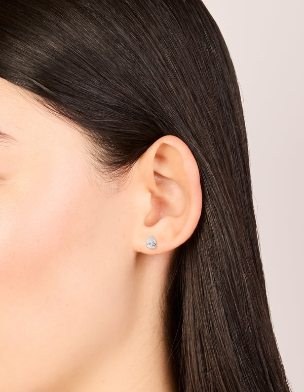 These sterling silver cubic zirconia pear stud earrings on ear view