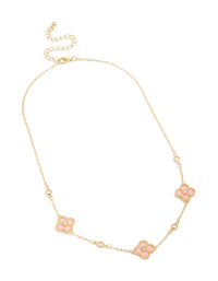 Highlighting a gold plated pink cubic zirconia flower trio necklace with dainty style close up view - link has visual effect only