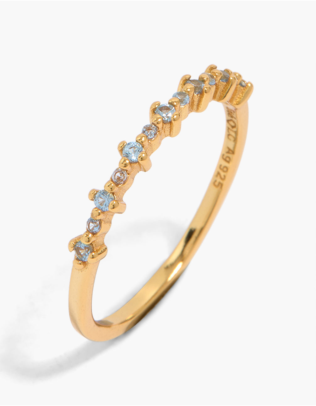 Showcasing a gold plated sterling silver band ring featuring light blue cubic zirconia front view