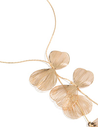 Showcasing a laser cut petals Y-necklace with statement style in gold close up view - link has visual effect only
