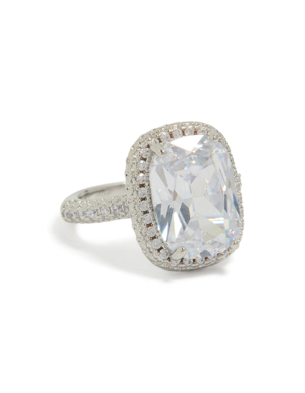 Showcasing a statement ring with cushion cut cubic zirconia and halo crystal detailing in silver and clear front view