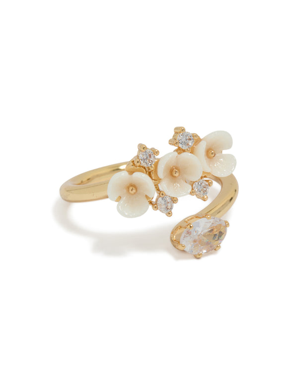 Showcasing a gold plated triple flower wrap ring with statement floral design in ivory and white side detail view