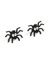 Showcase a playful pair of black coated metal spider face stud earrings in white and black front view - link has visual effect only