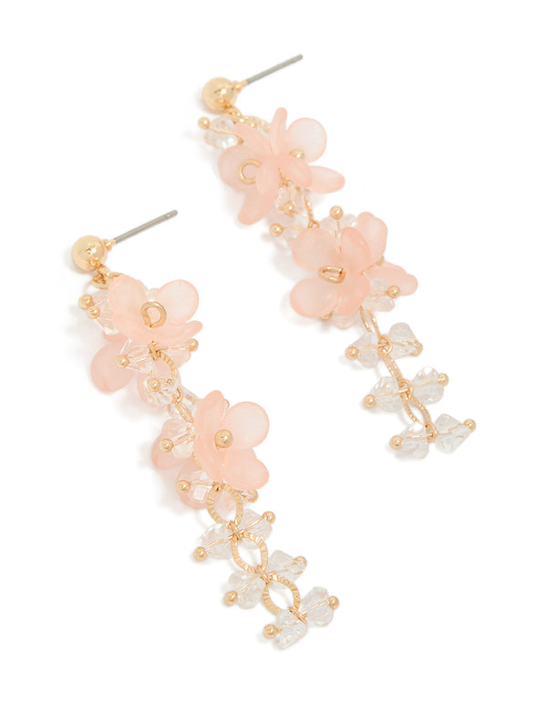 Showcasing statement drop earrings featuring beaded charms with floral in pink and beige front view