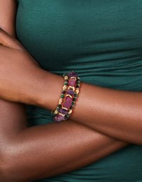 Crafted from beads and balls these chunky mixed stretch bracelets in a 3-pack showcase dark magenta, gold, green, and black tones on wrist view - link has visual effect only