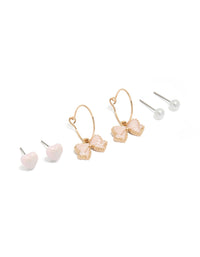 Showcasing gold pearl heart and bow earrings in a 3-pack with hoop and stud closures, pink and white accents front view - link has visual effect only