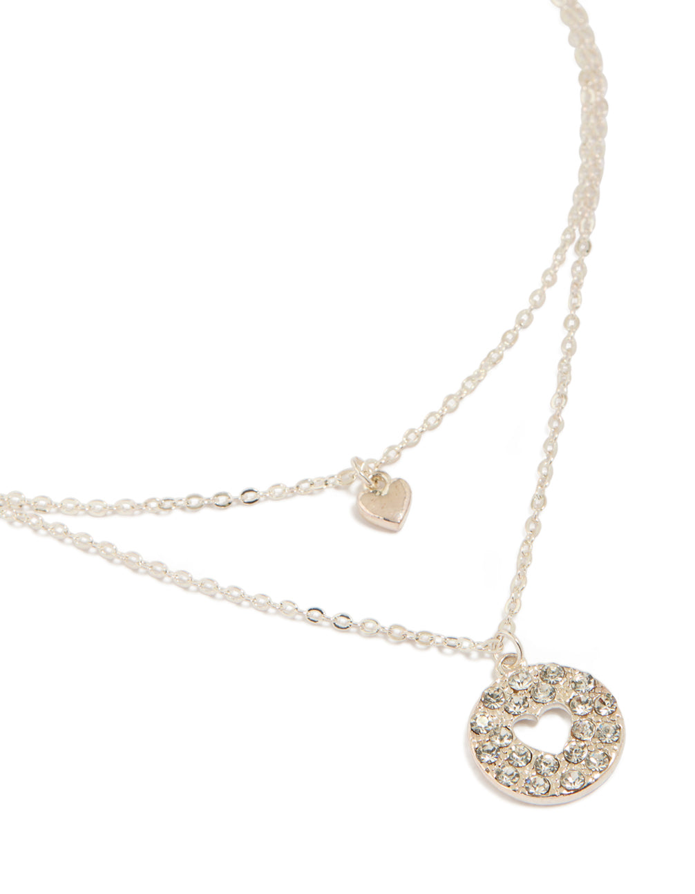 Showcasing a silver heart cutout pendant layered necklace dainty styling close up view
