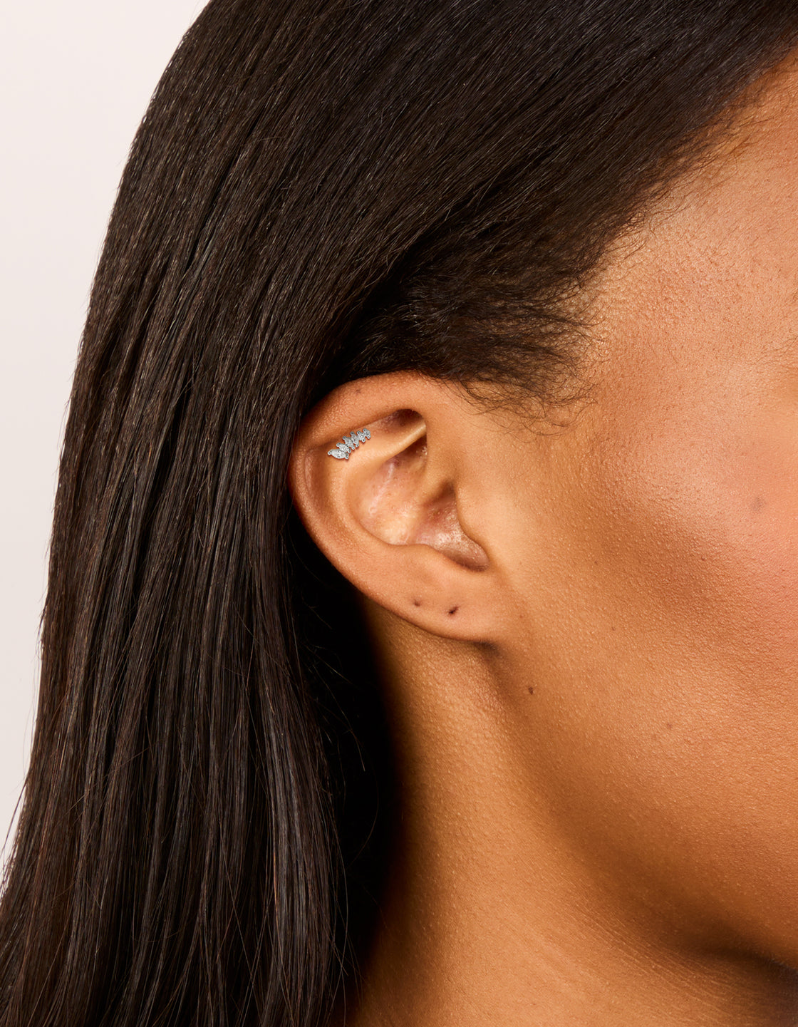Featuring a crawler style single flat back stud earring crafted from surgical steel with cubic zirconia on ear view